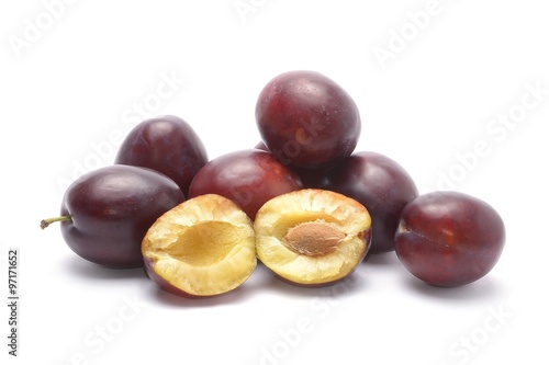 Purple plums isolated on white background