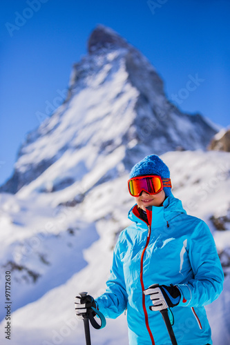 Skier woman with view of Matterhorn on a clear sunny day - Zermatt, Switzerland