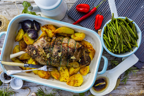 Lamb meat - roasted leg of lamb with rosemary, spices and roasted potatoes
 photo