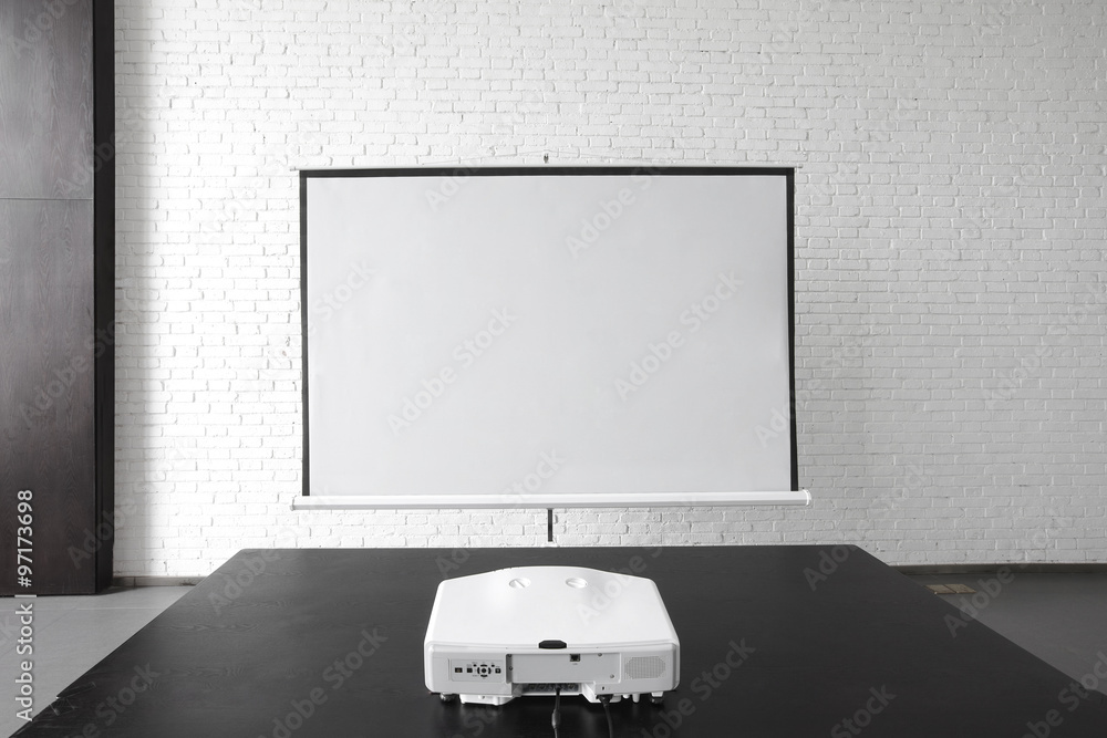Blank projector canvas in the office - obrazy, fototapety, plakaty 