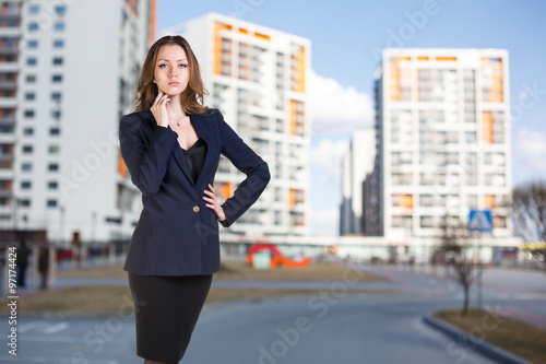 Businesswoman stands on the street photo