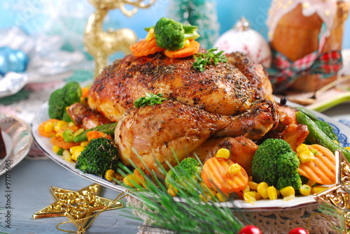 roasted chicken with vegetables on christmas table