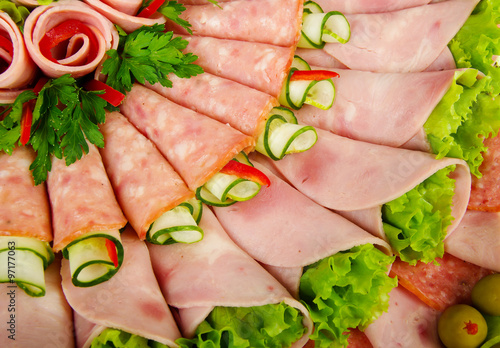 rolls of processed meat garnished with lettuce photo