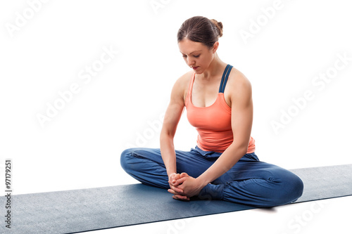 Woman practices yoga asana Baddha konasana photo