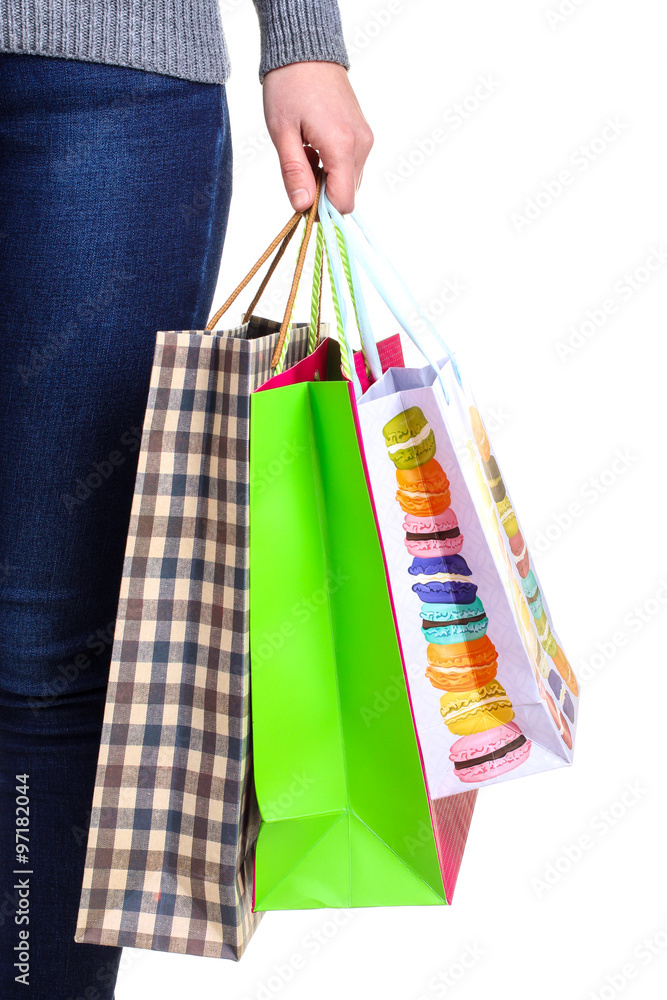 Colorful shopping bags for shopping in the hand of the woman isolated on white background