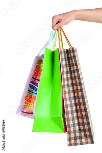 Colorful shopping bags for shopping in the hand of the woman isolated on white background