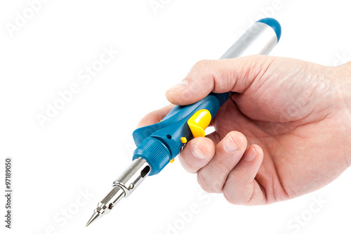 Gas soldering iron in hand on a white background.