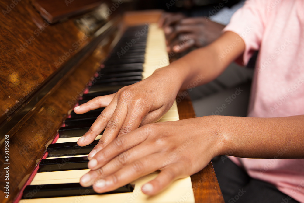 Fototapeta premium Girl learning play piano with her dad