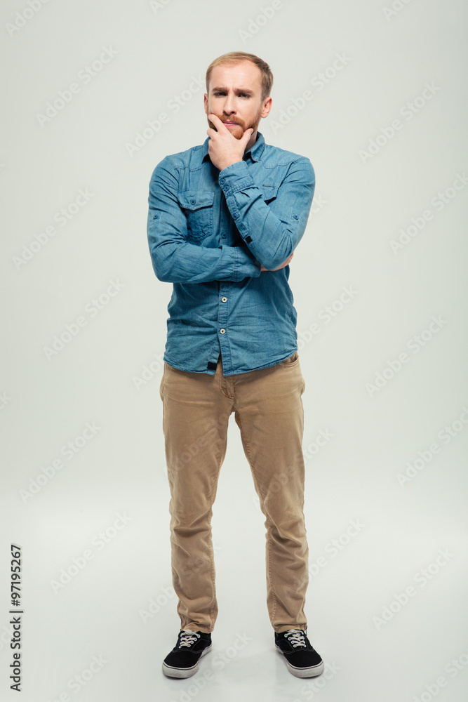 Full length portrait of a casual pensive man Full length portrait of a casual pensive man