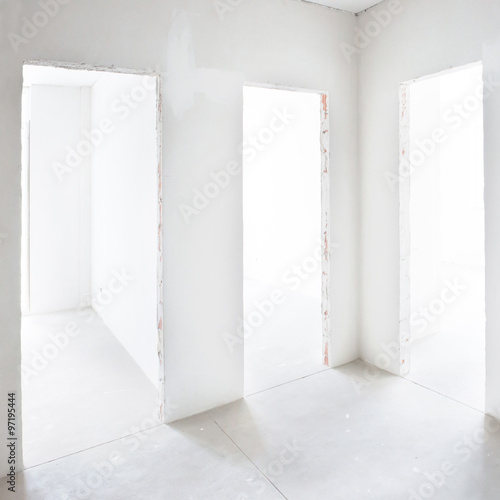 Three doors in white room