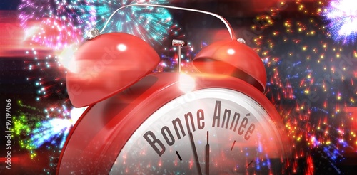 Composite image of bonne annee in red alarm clock photo