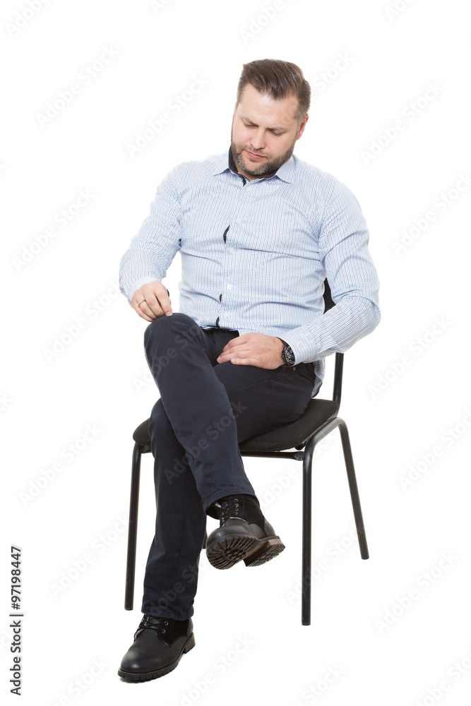 man sitting on chair. Isolated white background. Body language. picking  nonexistent lint Stock Photo | Adobe Stock