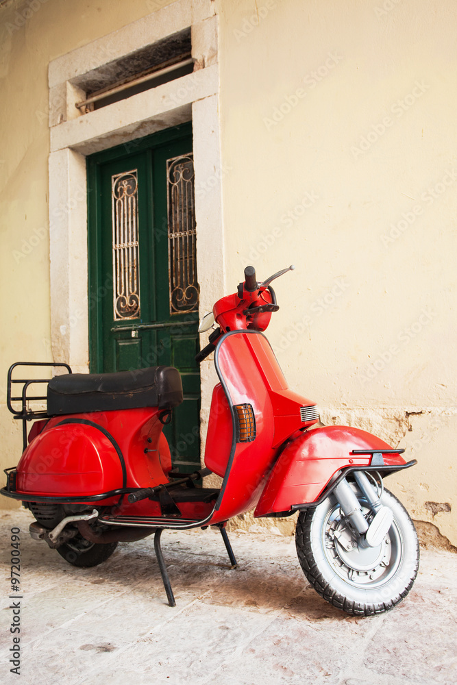 Red scooter on a city street