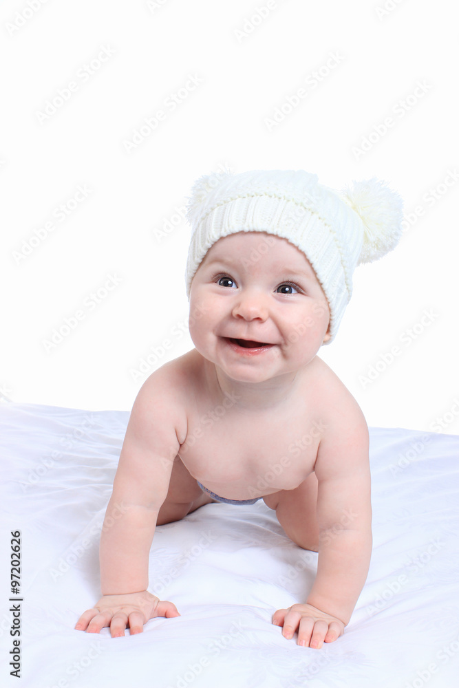 Portrait of adorable baby on the bed in the cap Portrait of adorable baby on the bed in the cap