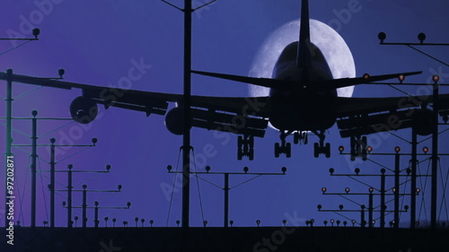 HD footage of a night landing by a jumbo jet as it cross the moon, then rack focuses out at the end.  Audio included
