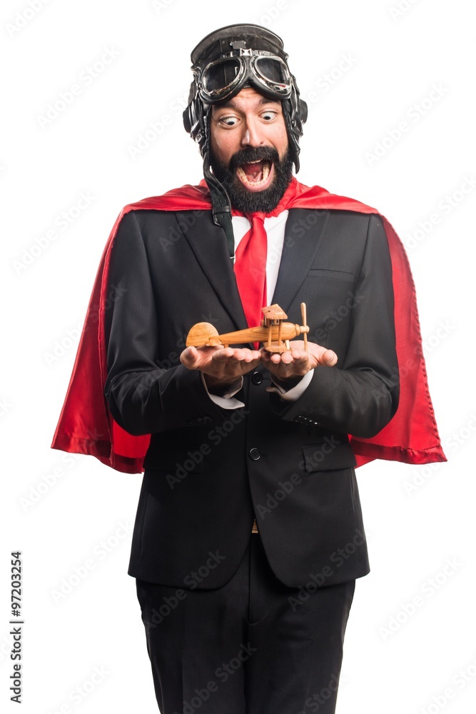 Super hero businessman holding a wooden toy airplane Super hero businessman holding a wooden toy airplane