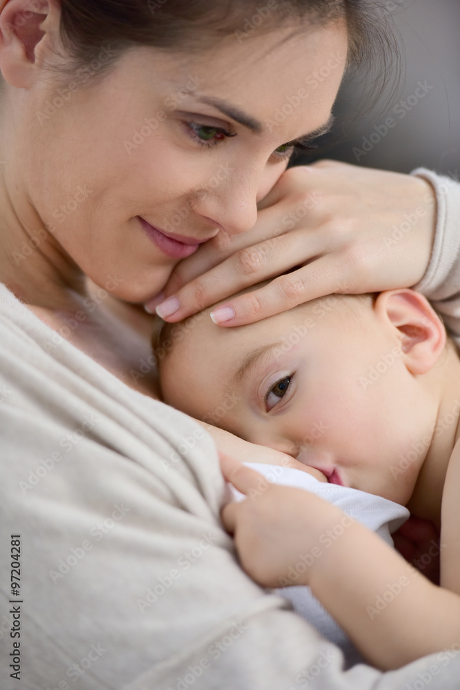 Mom breast feeding baby girl Mom breast feeding baby girl