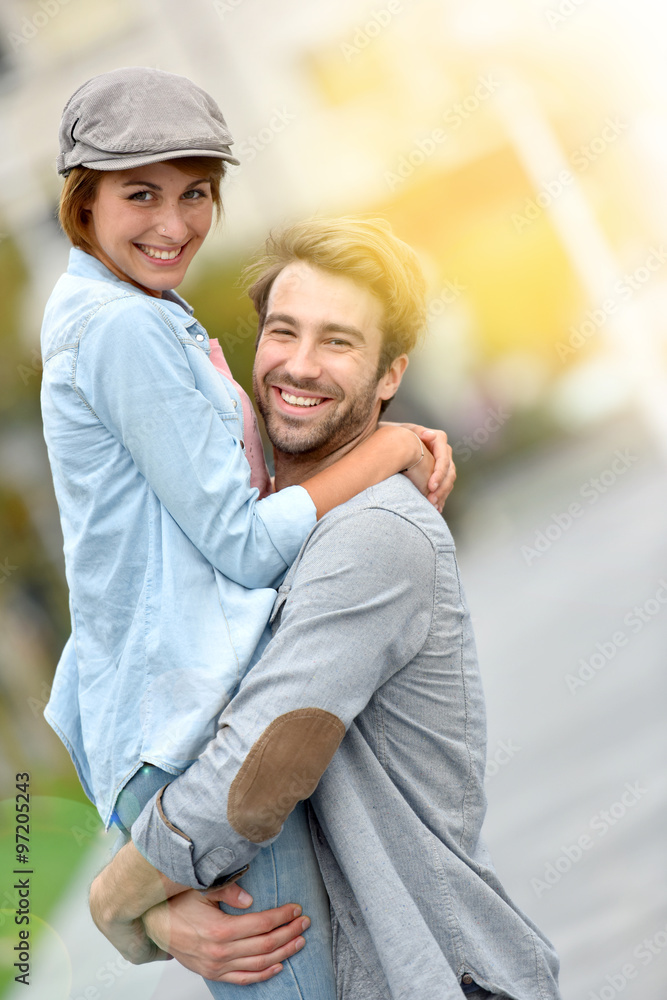 Cheerful man lifting girl up in arms