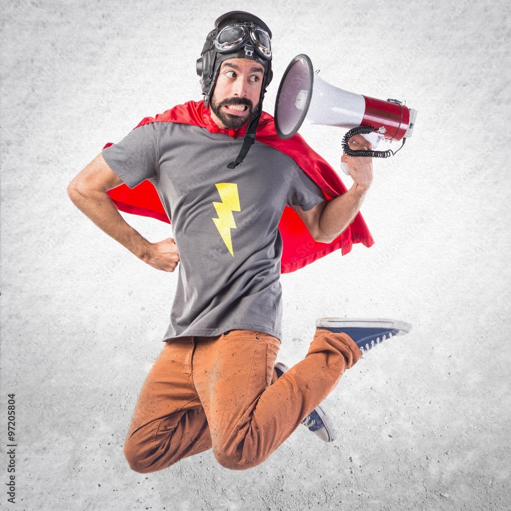 Superhero shouting by megaphone Stock Photo | Adobe Stock