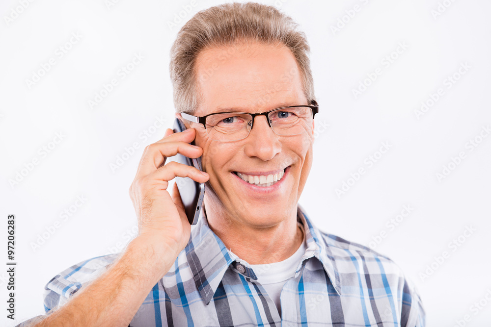 Handsome happy aged man talking on the phone Handsome happy aged man talking on the phone