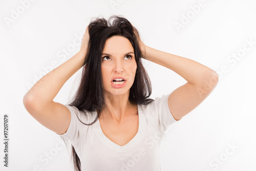 Portrait of crazy girl shouting and holding hair