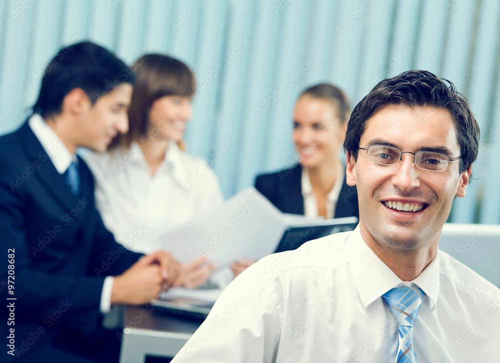Portrait of successful businessman and business team at office m Portrait of successful businessman and business team at office m