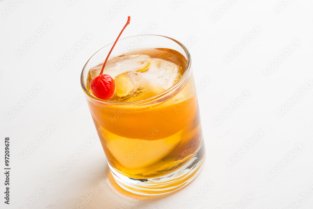 Old fashioned cocktail with cherry and orange peel Old fashioned cocktail with cherry and orange peel