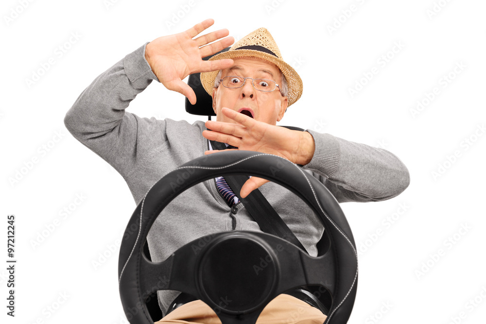 Scared senior sitting on a car seat and gesturing