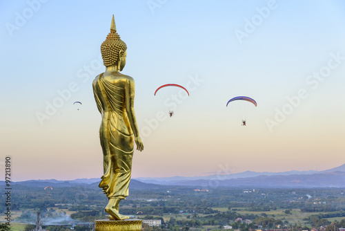 the standing Buddha statue with the para motor player before the sun set 