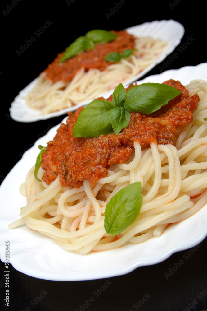Spaghetti ragu alla bolognese sauce on black,close up Spaghetti ragu alla bolognese sauce on black,close up