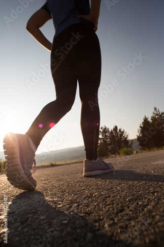 Young woman stretching before running in the early evening, inst