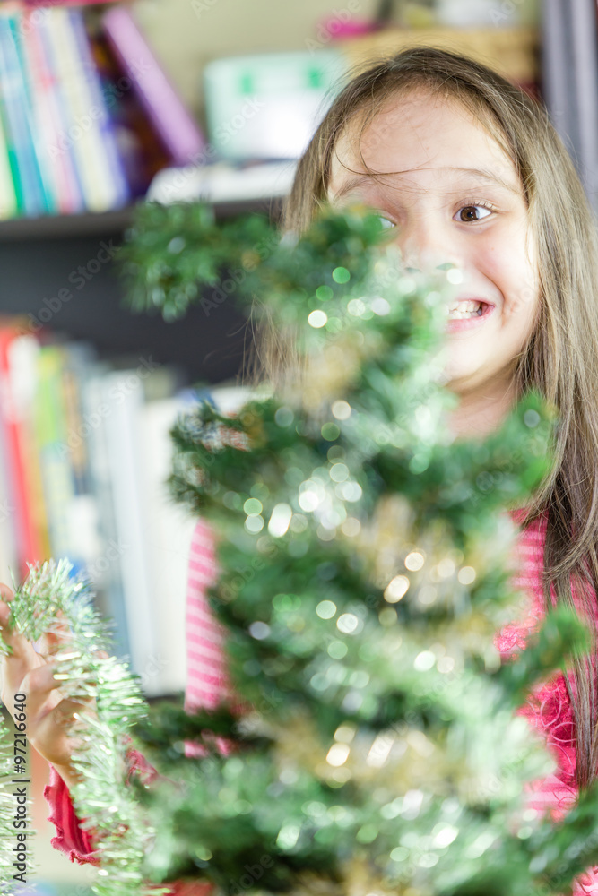 Little girl decorating Christmas tree Little girl decorating Christmas tree