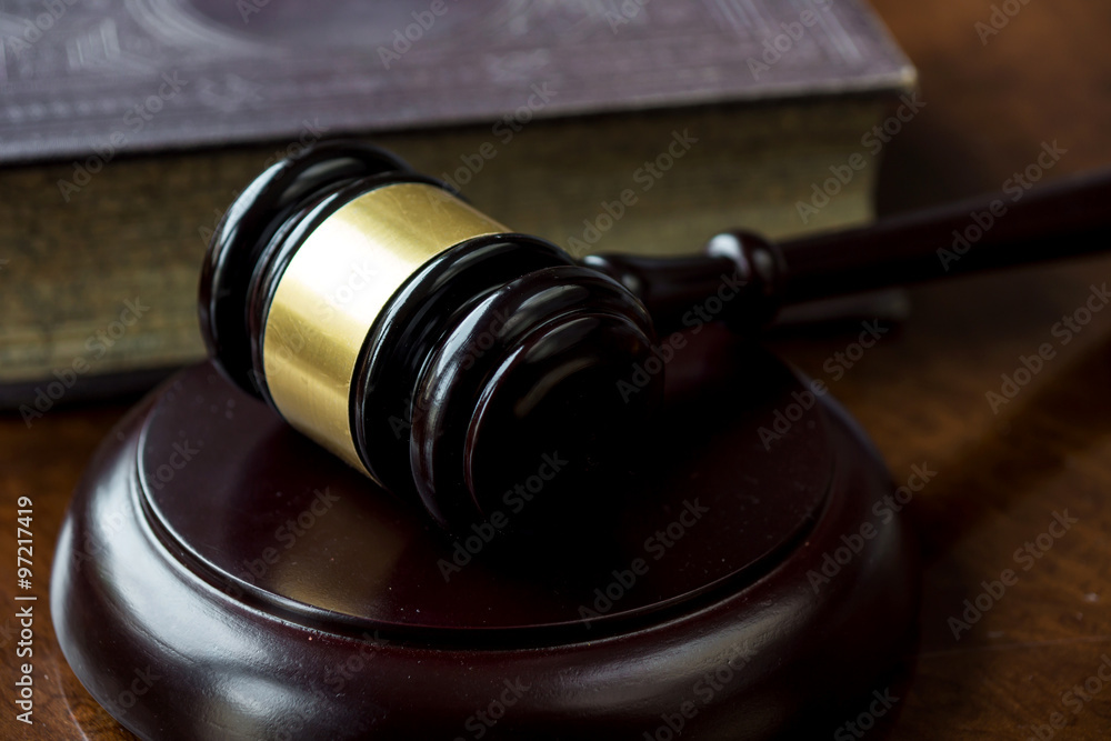 Wooden gavel and book on wooden table Wooden gavel and book on wooden table