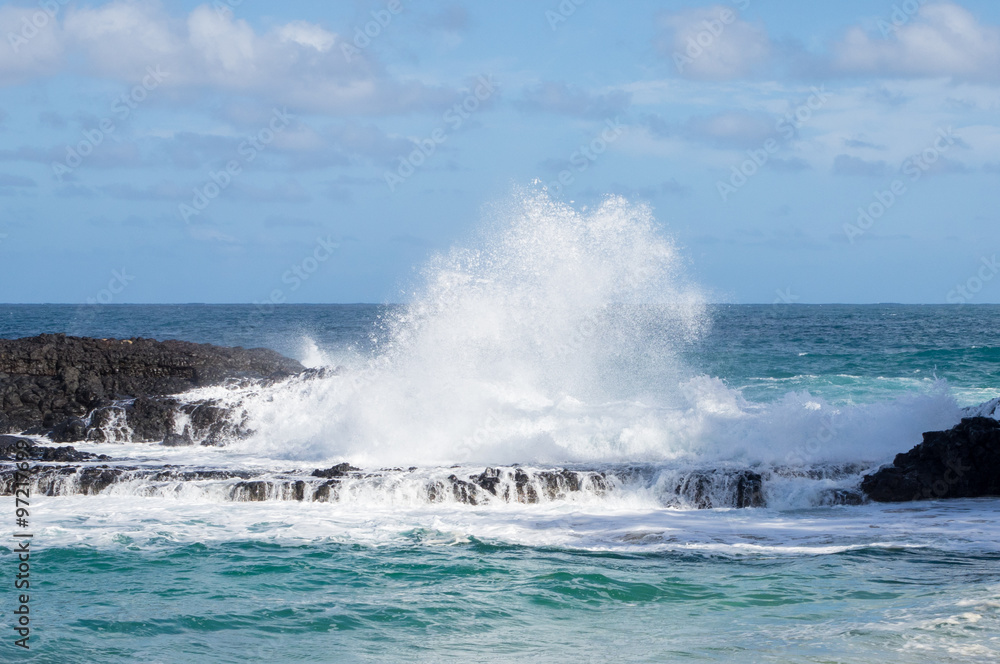 Powerful waves flow over rocks at Lumahai Beach, Kauai