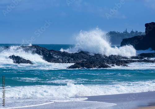 Powerful waves flow over rocks at Lumahai Beach, Kauai