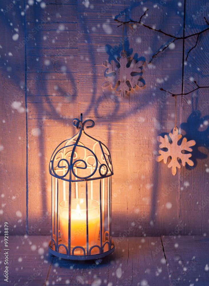 Christmas decorations and lantern at the evening . Focus on the wick candle