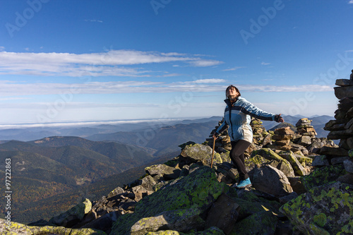 Girl on top of high mountains and open horizon