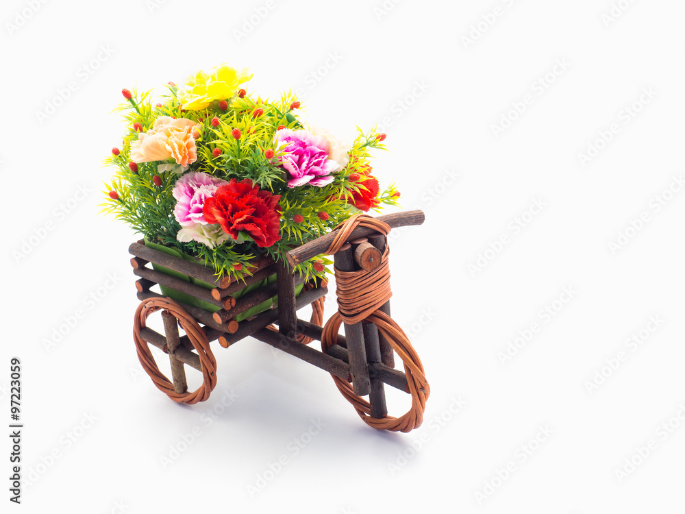 Handmade wooden tricycle toy with flower in the basket isolated