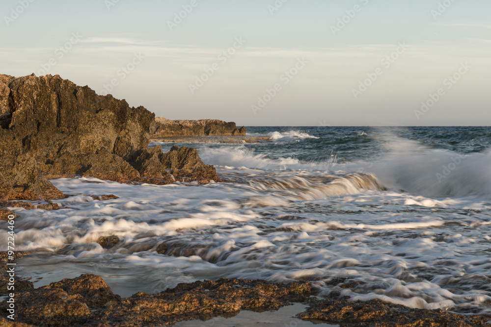 Fototapeta premium Rocky shore. Sunset over the sea