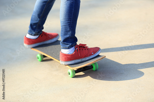 skateboarding legs riding on a skateboard