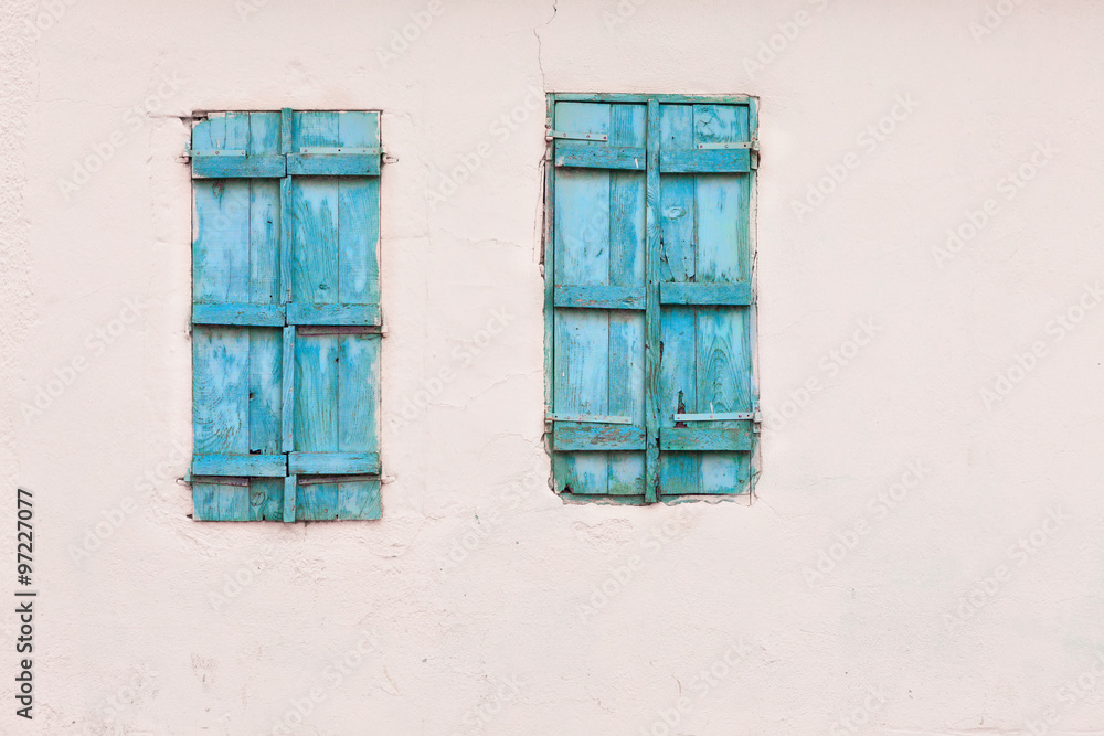 Blue painted wooden window and white wall Blue painted wooden window and white wall