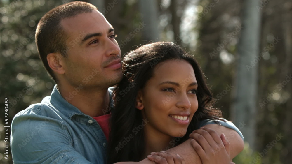 Young couple embracing and smiling Young couple embracing and smiling