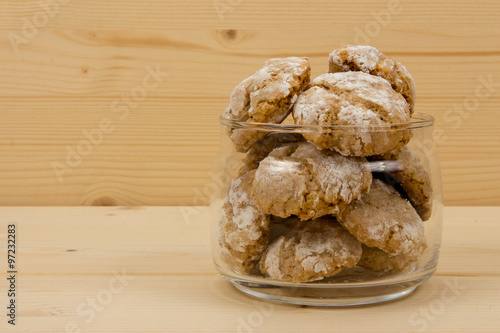 Italian almond cookies in jar on wooden table 2