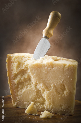Parmesan cheese cutting on the chopping board