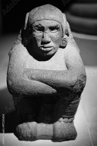 Obraz na plátně Closeup of an old stone sculpture of an aborige sitting