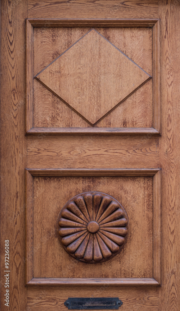 Detail of old wooden door decorated with shapes carved in wood Detail of old wooden door decorated with shapes carved in wood