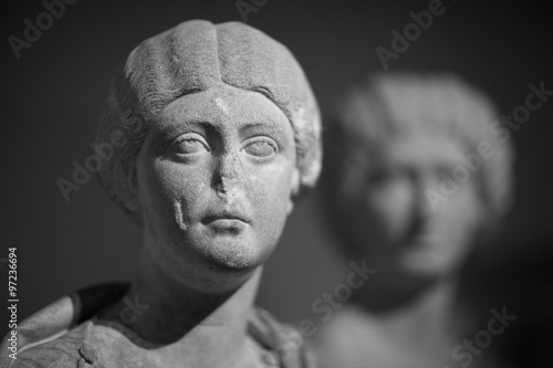Old statue of young lady with broken nose photo