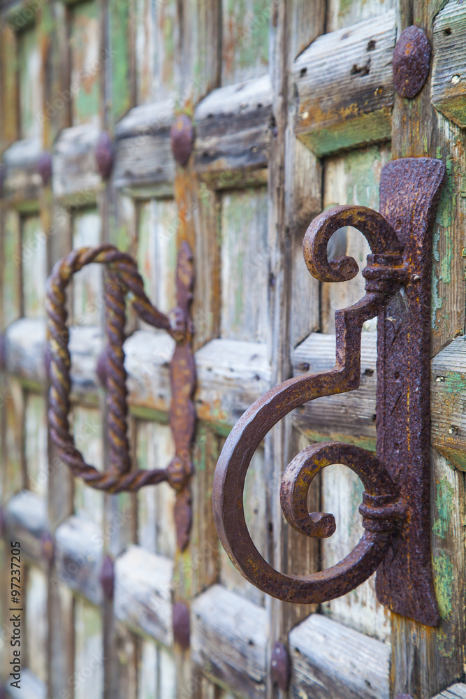 Old wooden door with rusty handles Old wooden door with rusty handles