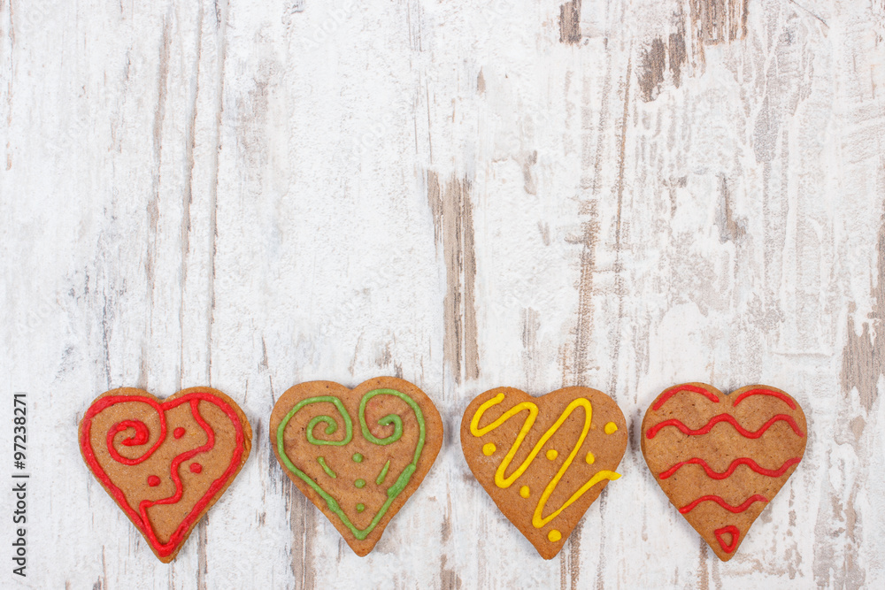 Fresh baked decorated gingerbread on old wooden background, christmas time Fresh baked decorated gingerbread on old wooden background, christmas time