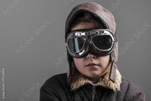 child playing the aircraft pilot with hat and retro bomber jacke